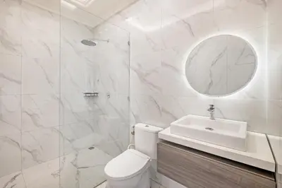 a bathroom with a toilet and a sink and a mirror at Desa Residence Kerobokan in Kerobokan