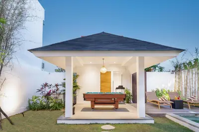 a gazebo with a pool table in a backyard at Villa ElyOs Canggu by Nagisa Bali in Canggu