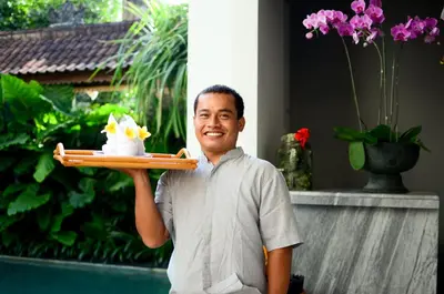a man holding a tray with a dessert on it at Room & Vespa 1 - Stay Central Seminyak Near Beach in Seminyak