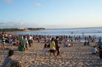 a large crowd of people on a beach at Graha Wedha Suite Kuta by kamara in Kuta