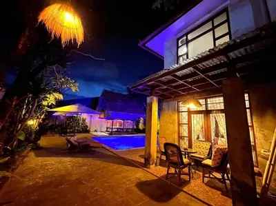 a house with a swimming pool at night at kuta 5BR private villa pool ,near airport, in Kuta
