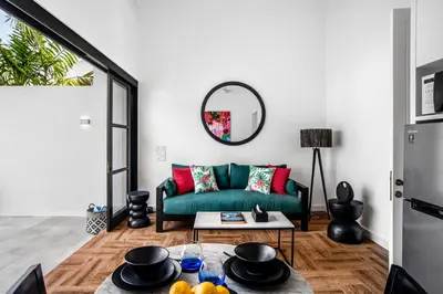 a living room with a green couch and a table at Villa Balik II Seminyak in Seminyak