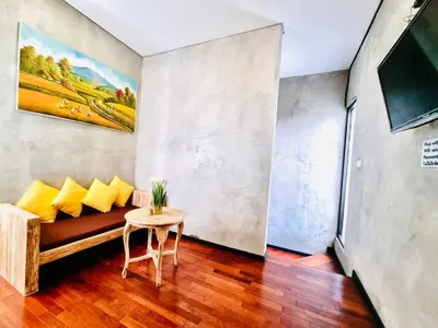 a living room with a couch and a table at Bali 3BR Family Nicho House in Seminyak