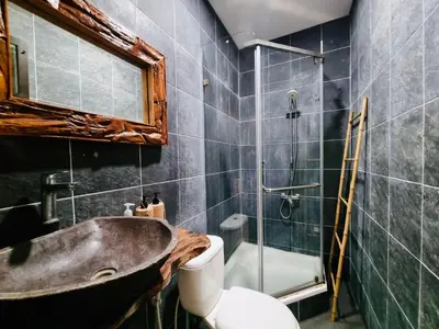 a bathroom with a sink and a shower and a toilet at Bali 3BR Family Nicho House in Seminyak