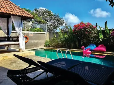 a swimming pool with a table and chairs next to it at Casa de Prospera - 3BR Villa with Private Pool in Nusa Dua