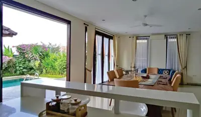 a kitchen and living room with a table and a pool at Casa de Prospera - 3BR Villa with Private Pool in Nusa Dua