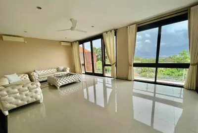 a living room with white furniture and large windows at Casa de Prospera - 3BR Villa with Private Pool in Nusa Dua