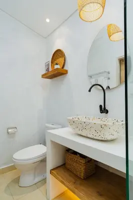 a bathroom with a sink and a toilet at Villa Aarna - Tropical Chic Private Oasis in Seminyak in Seminyak