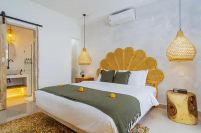 a bedroom with a large bed with oranges on it at Villa Aarna - Tropical Chic Private Oasis in Seminyak in Seminyak