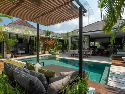 an outdoor living room with a couch and a swimming pool at Villa Naura Umalas in Dalung