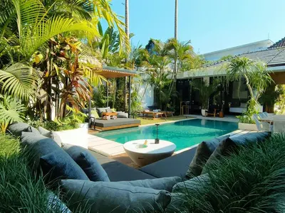 a backyard with a swimming pool and a house at Villa Naura Umalas in Dalung