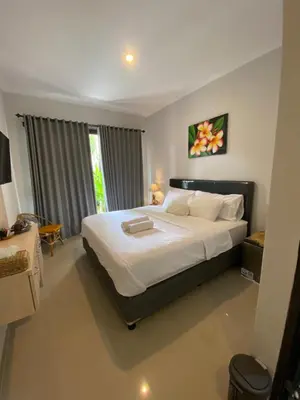 a bedroom with a large bed with white sheets at Queen’s Villa in Seminyak