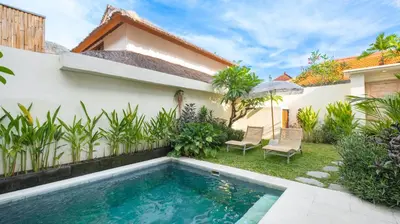 a swimming pool in the backyard of a house at Villa Ambalika by Villa Finder in Seminyak