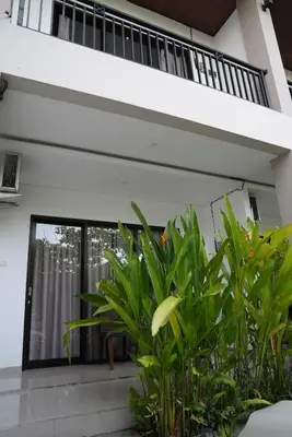 a view of the front door of a house with plants at Doris Seminyak Studio in Seminyak