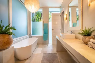 a bathroom with a large tub and a large window at Villa Sunsara 4 - Enchanting 4BR Villa in a Great Location in Canggu