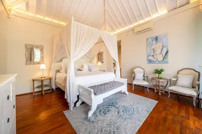 a bedroom with a white bed with a canopy at Villa Sunsara 4 - Enchanting 4BR Villa in a Great Location in Canggu