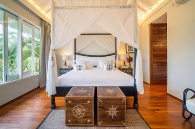 a bedroom with a bed with a canopy at Villa Sunsara 4 - Enchanting 4BR Villa in a Great Location in Canggu