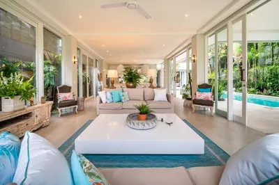 a living room with a couch and a table at Villa Sunsara 4 - Enchanting 4BR Villa in a Great Location in Canggu