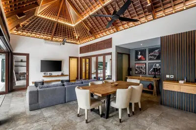 a living room with a table and a couch at Villa Iris in Dalung