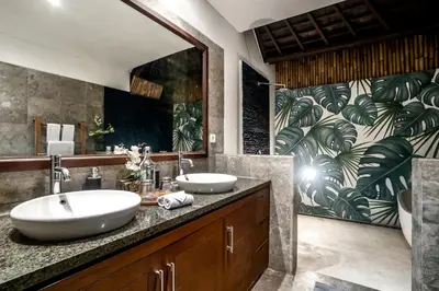 a bathroom with two sinks and a large mirror at Villa Iris in Dalung