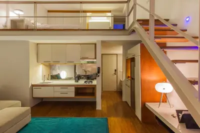 an open kitchen and living room in a loft at Petitenget 501 in Seminyak