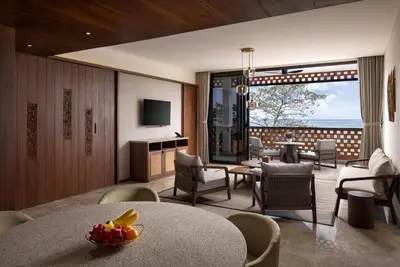 a living room with a table and chairs at Sumitra Luxury Villas & Resort by Pramana in Sanur