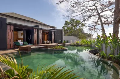 an external view of a house with a swimming pool at Sumitra Luxury Villas & Resort by Pramana in Sanur