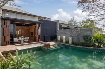 a swimming pool in the backyard of a house at Sumitra Luxury Villas & Resort by Pramana in Sanur