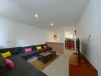 a living room with a couch and a table at Batu Belig Living by CPM Bali in Seminyak