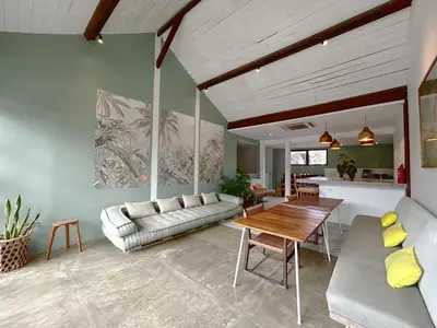 a living room with a couch and a table at Batu Belig Living by CPM Bali in Seminyak