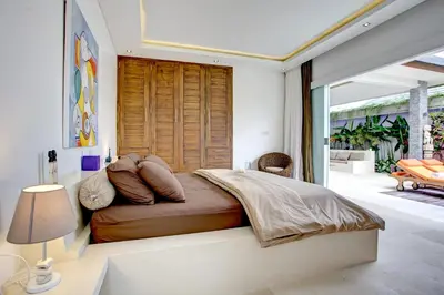 a bedroom with a large bed and a balcony at Villa Jonas seminyak Bali in Seminyak