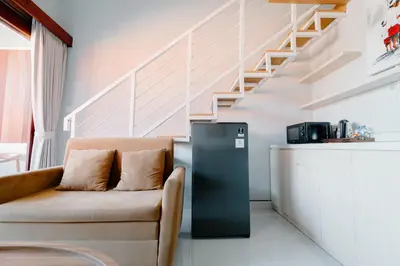a living room with a refrigerator and a couch at Pondok Puspa Sumekar in Seminyak