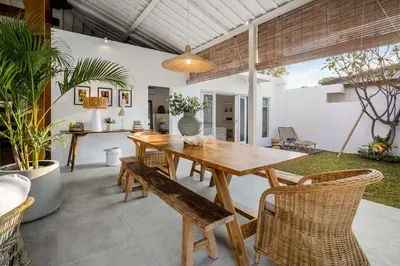 a dining room with a wooden table and chairs at A Casa Di Renucci by Alfred in Bali in Seminyak
