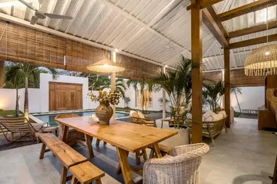 a dining room with a wooden table and chairs at A Casa Di Renucci by Alfred in Bali in Seminyak