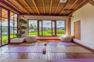 an empty room with yoga mats and windows at 7BR Villa Private Pool Yoga Gym Cinema 10min Canggu Surfing Beach in Kerobokan