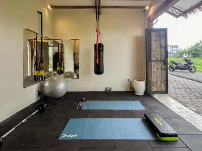 a room with a gym with mats on the floor at 7BR Villa Private Pool Yoga Gym Cinema 10min Canggu Surfing Beach in Kerobokan