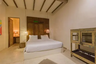 a bedroom with a white bed and a fireplace at 7BR Villa Private Pool Yoga Gym Cinema 10min Canggu Surfing Beach in Kerobokan