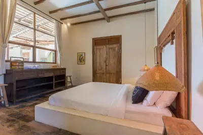 a bedroom with a large bed and a window at 7BR Villa Private Pool Yoga Gym Cinema 10min Canggu Surfing Beach in Kerobokan