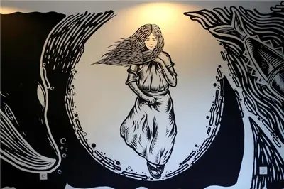 a drawing of a woman walking through a portal at 7 Bidadari Hotel Seminyak in Seminyak