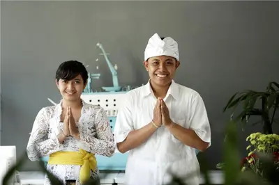 a man and a woman praying in a room at 7 Bidadari Hotel Seminyak in Seminyak