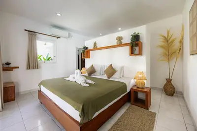 a bedroom with a bed with a stuffed animal on it at Newly renovated Villa Noa by Optimum Bali Villas in Seminyak