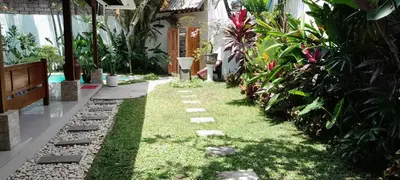 a garden with grass and rocks and plants at 2BR private villa in Seminyak, Ayu Putri in Seminyak