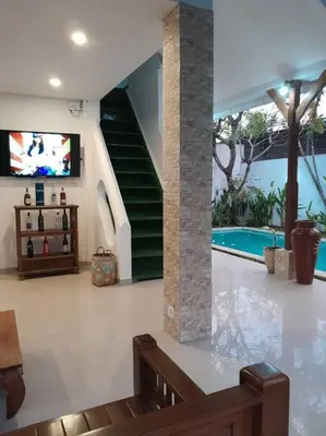 a living room with a tv and a swimming pool at 2BR private villa in Seminyak, Ayu Putri in Seminyak