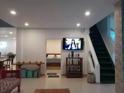 a living room with a tv and a staircase at 2BR private villa in Seminyak, Ayu Putri in Seminyak