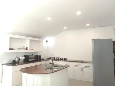a white kitchen with a sink and a refrigerator at 2BR private villa in Seminyak, Ayu Putri in Seminyak