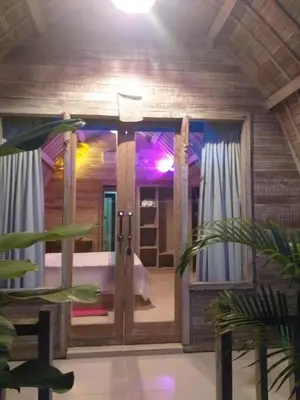 a bathroom with a glass door in a room at Villa Lumbung Krobokan in Seminyak
