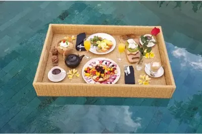 a miniature table with food on it in the water at Sol Bella VIlla 1 in Seminyak