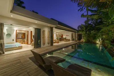a villa with a swimming pool and a bedroom at Villa Cuatro : Amazing 3BR Villa in Seminyak - Perfect Location in Seminyak
