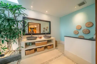 a bathroom with two sinks and a mirror at Villa Cuatro : Amazing 3BR Villa in Seminyak - Perfect Location in Seminyak