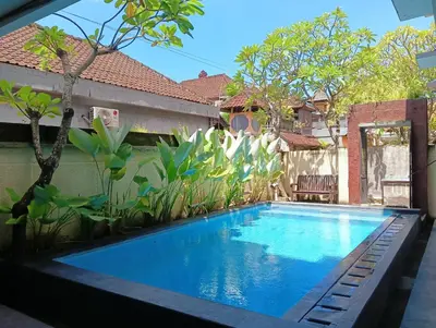 a swimming pool in the backyard of a house at Tama Seminyak Town House in Kerobokan